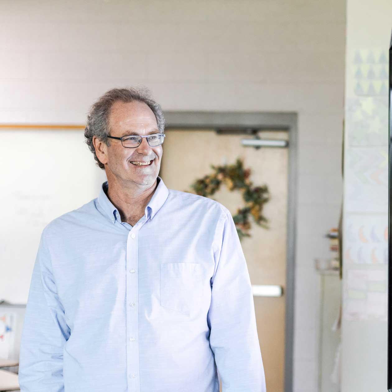 A man smiling while standing