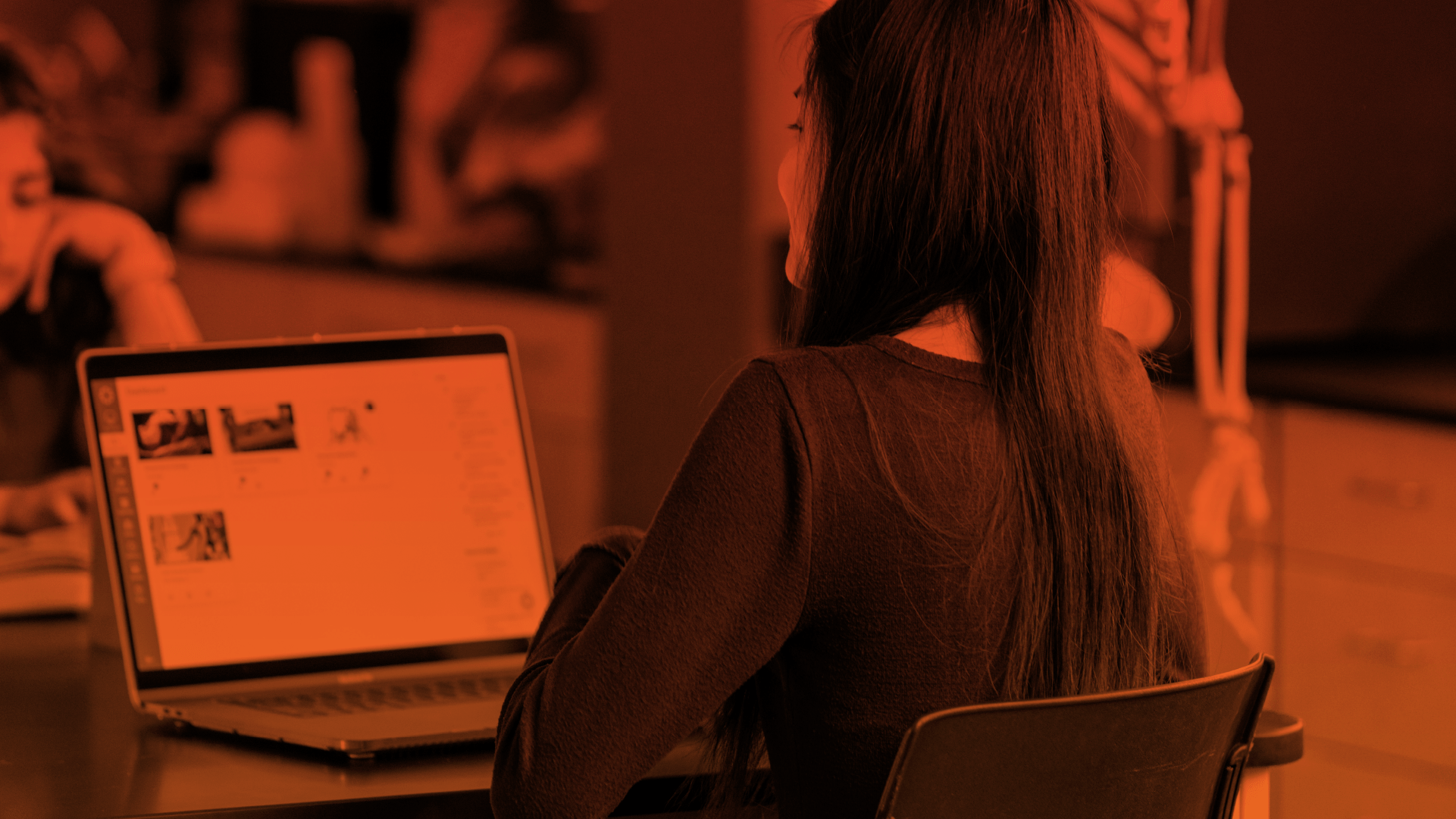 Students opening Canvas on their laptops while on class