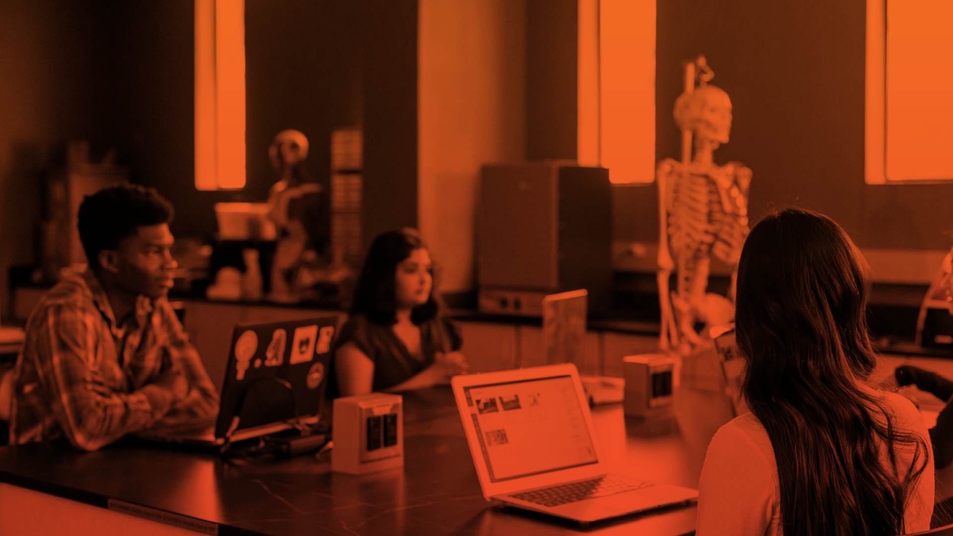 Students opening Canvas on their laptops while on class