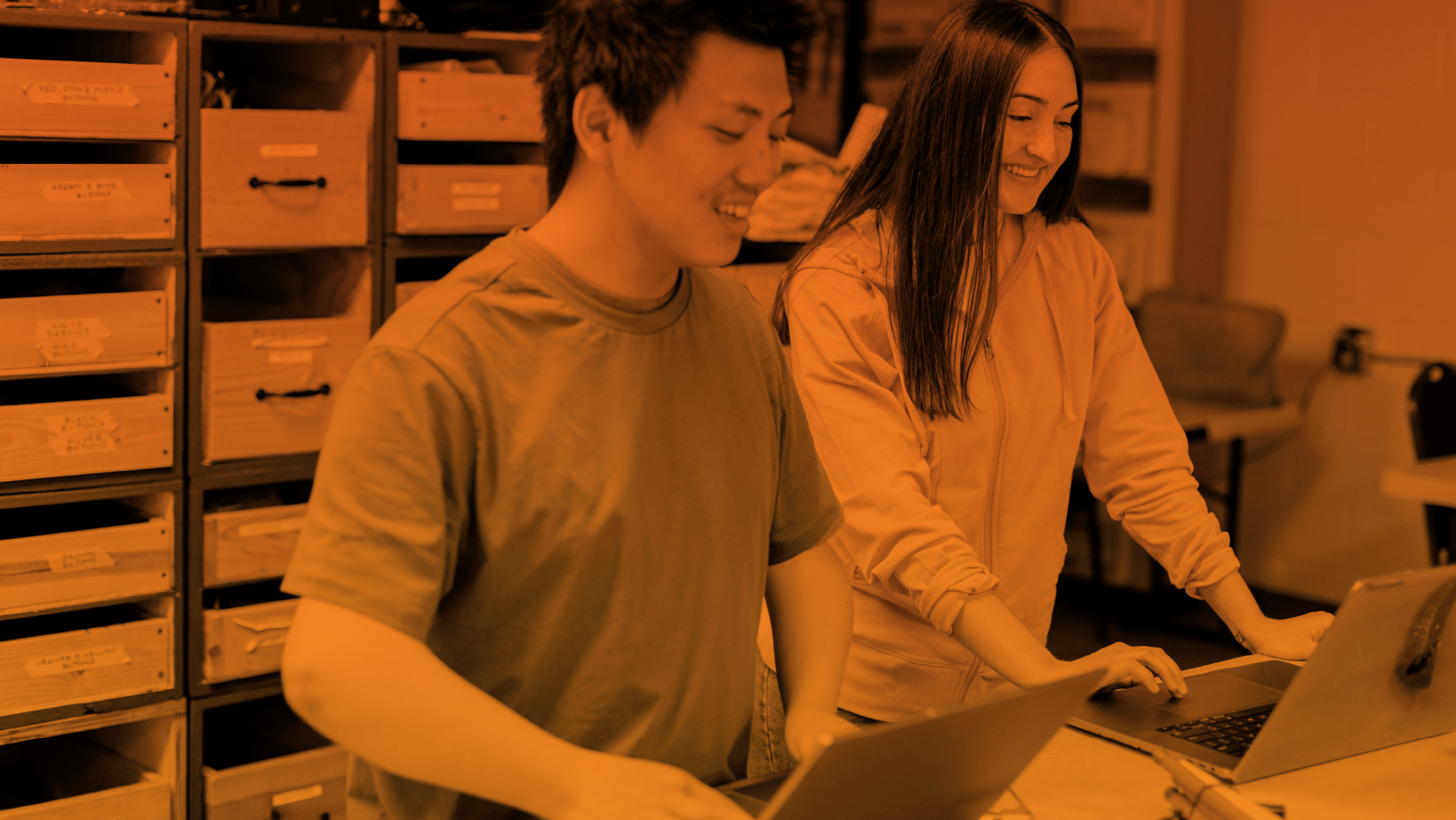 Students smiling while opening Canvas on their laptops 