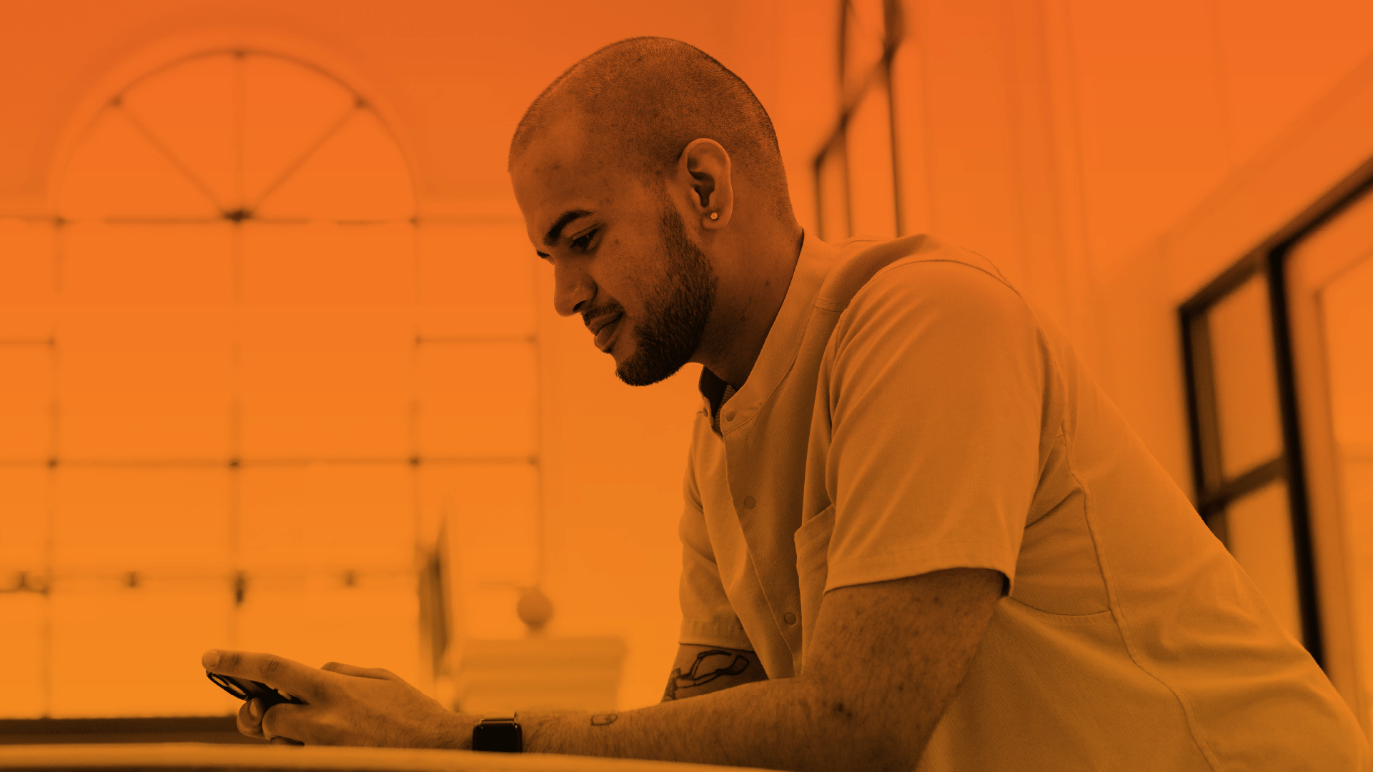 A student smiling while using a cellphone