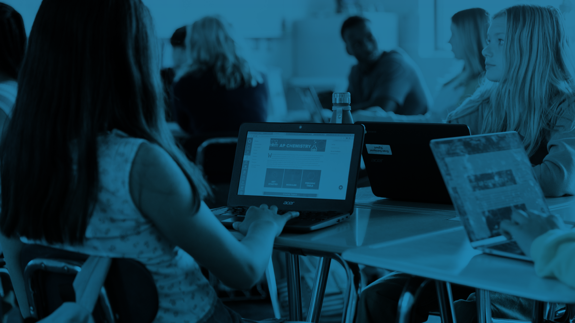 Students opening Canvas on their laptops while on class