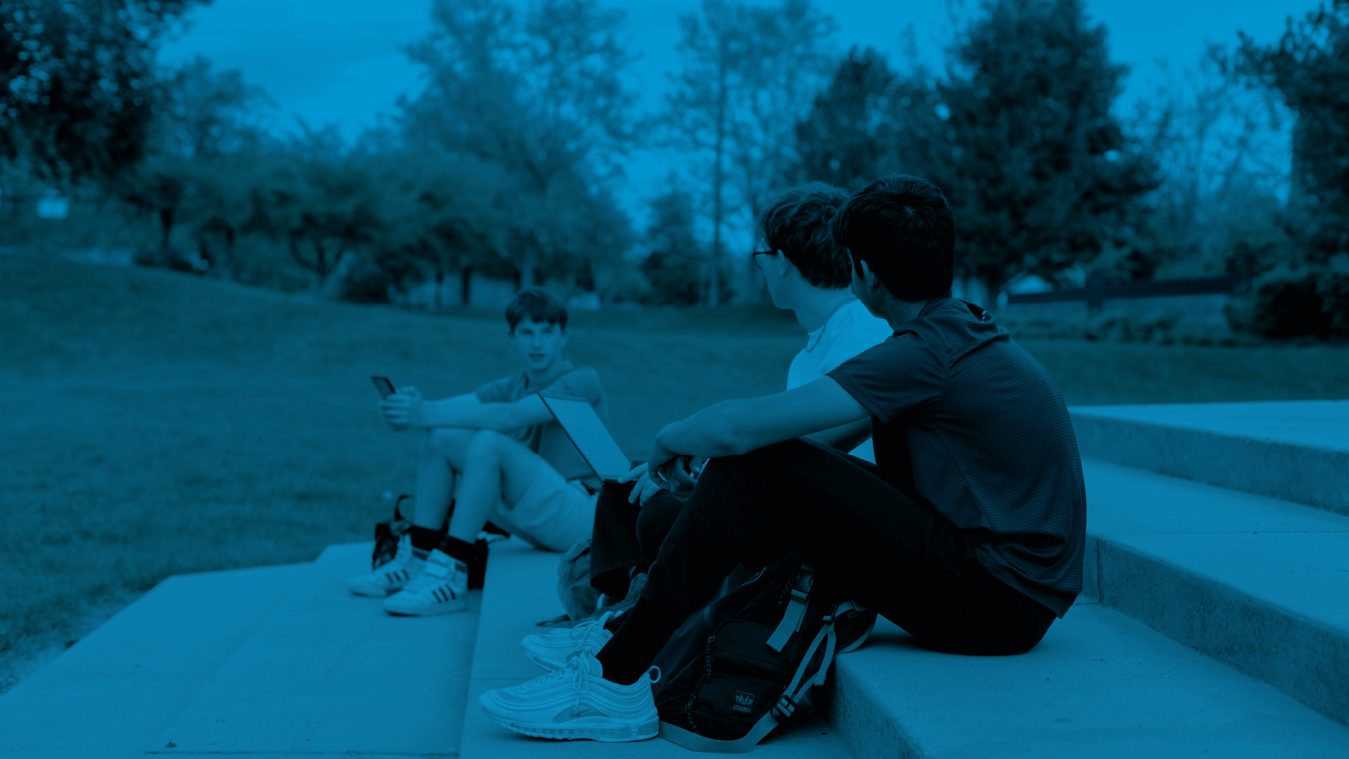 A group of students sitting on a ledge