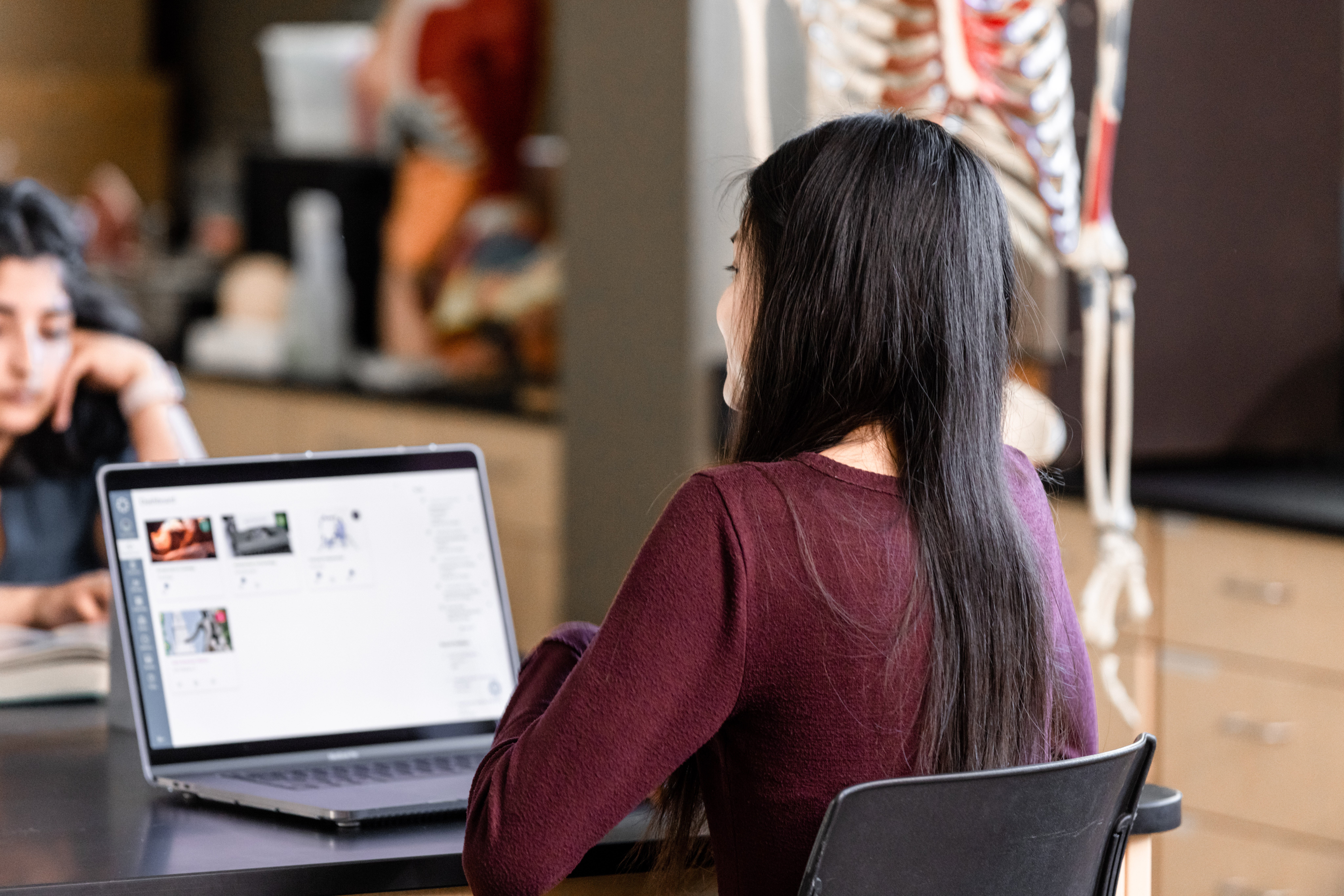Girl is on laptop accessing canvas course