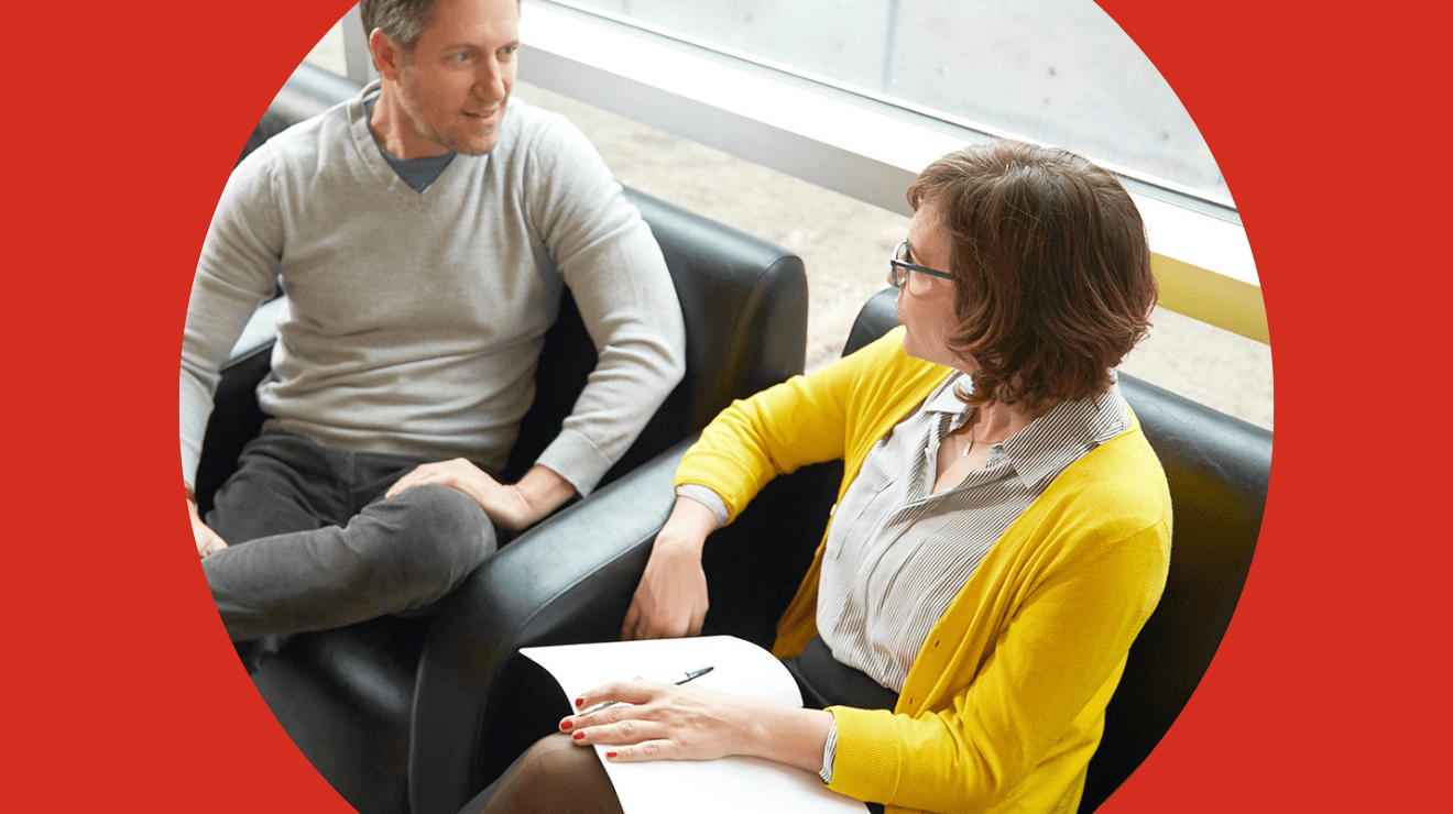 man and woman sitting and talking at each other