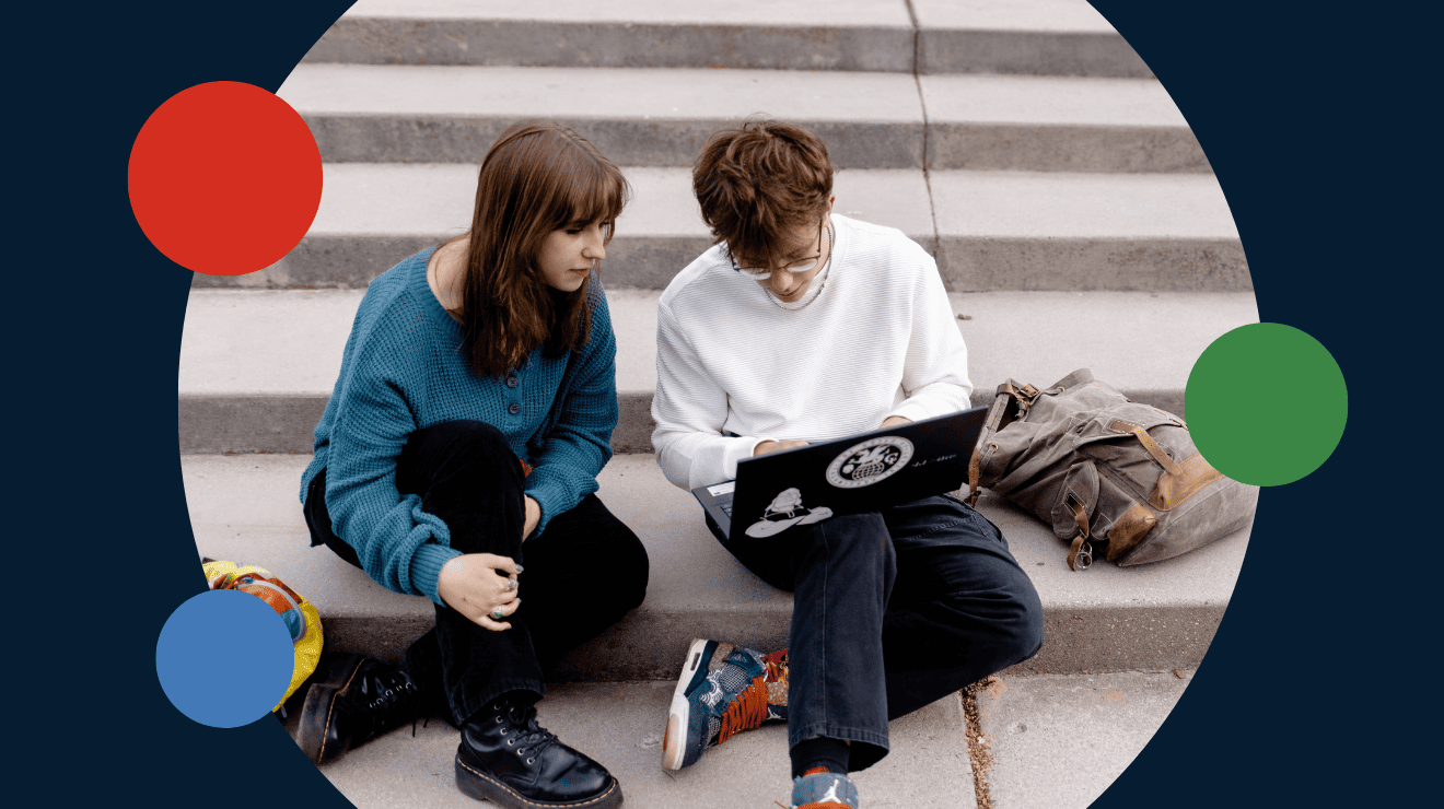 two students looking at a laptop