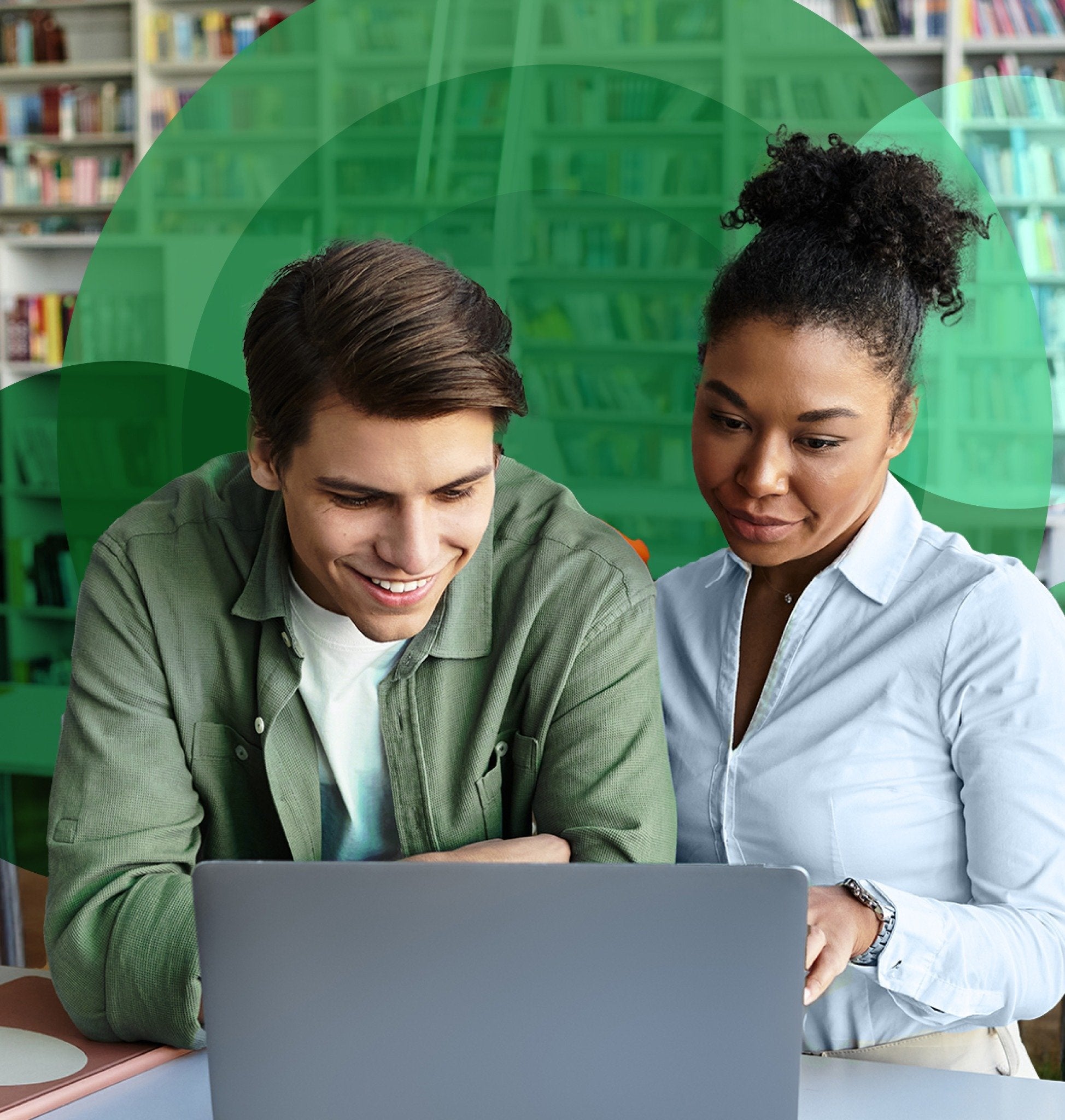 Students using Mastery Connect on a laptop inside of a library