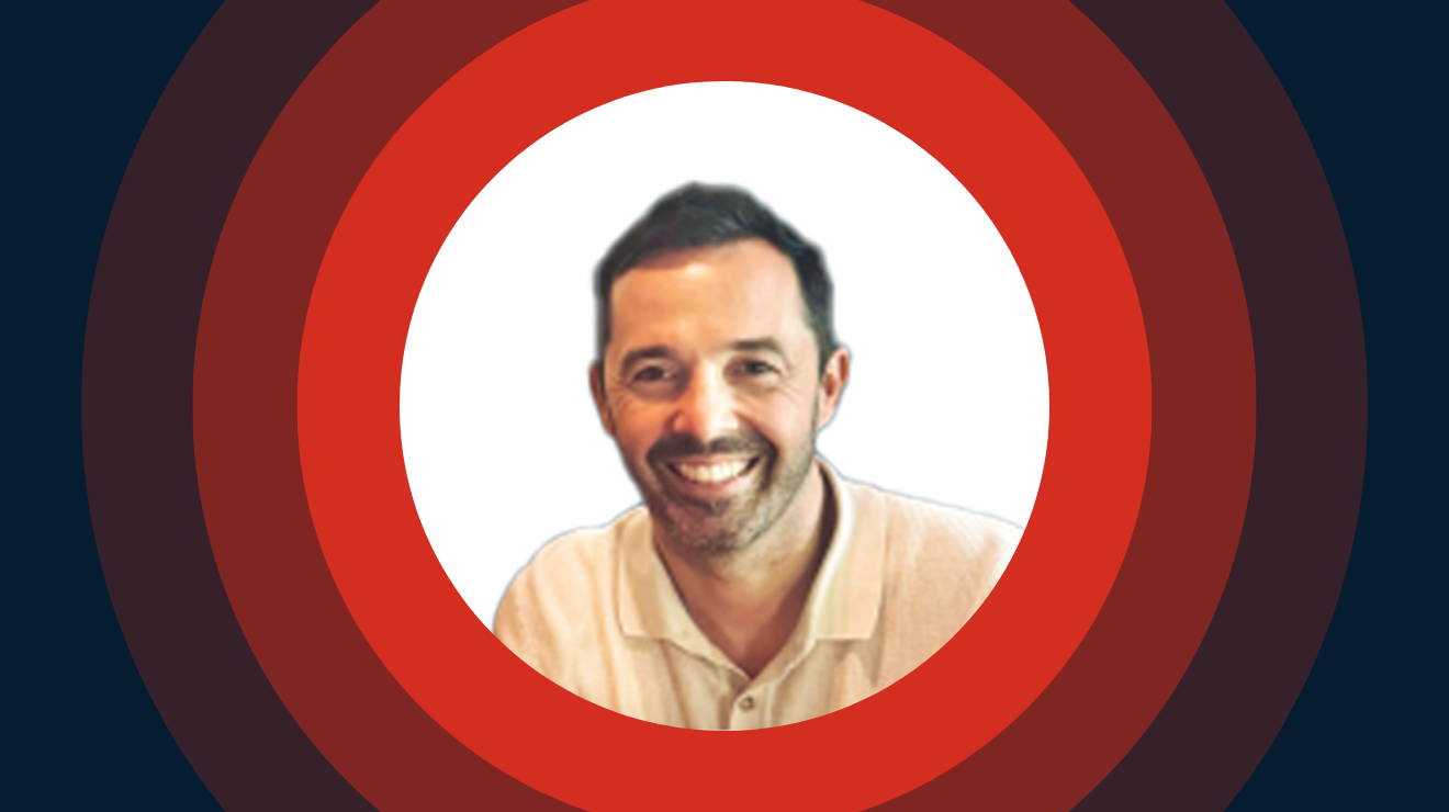 A cheerful man enclosed in a red circle with a white background.