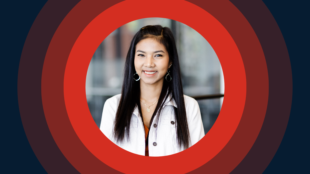 A woman with long black hair is centered in a red and blue circle, creating a vibrant and striking visual contrast.