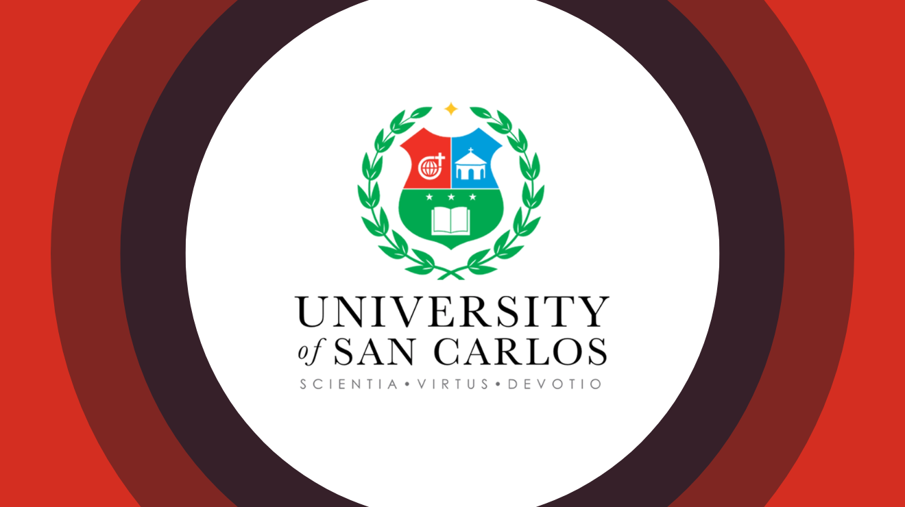 Logo of the University of San Carlos, depicting a shield with a book and torch, representing knowledge and learning.
