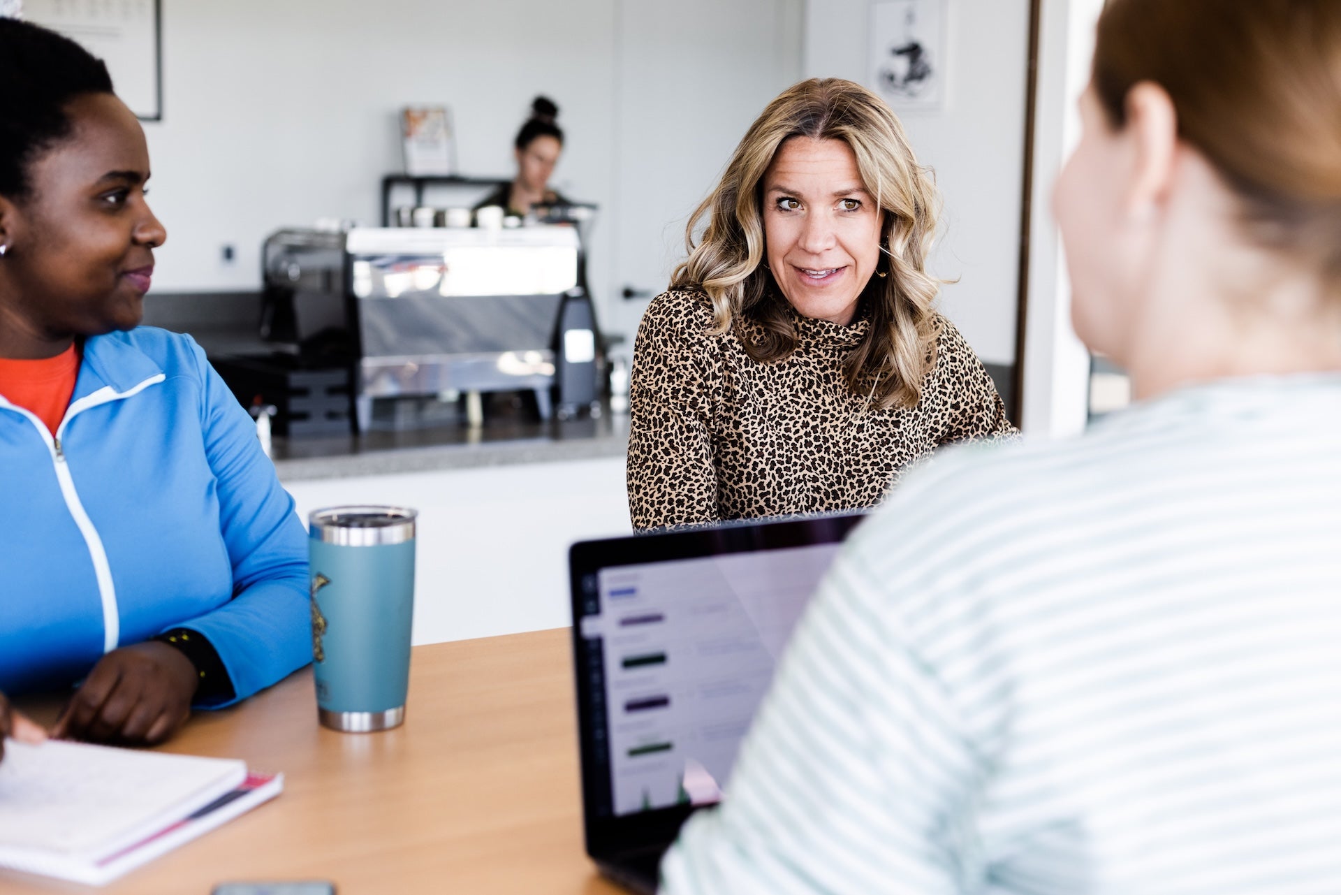 women speaking at desk