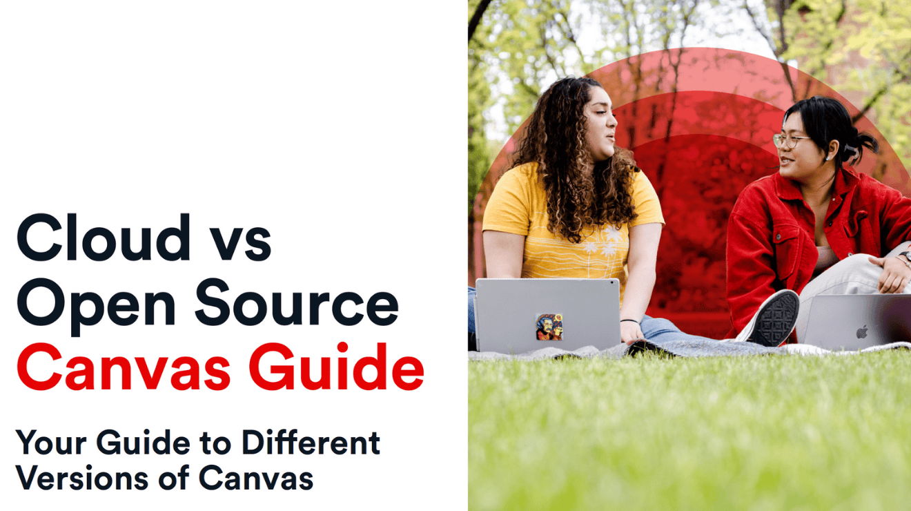 Two young women sitting on grass with an open laptop