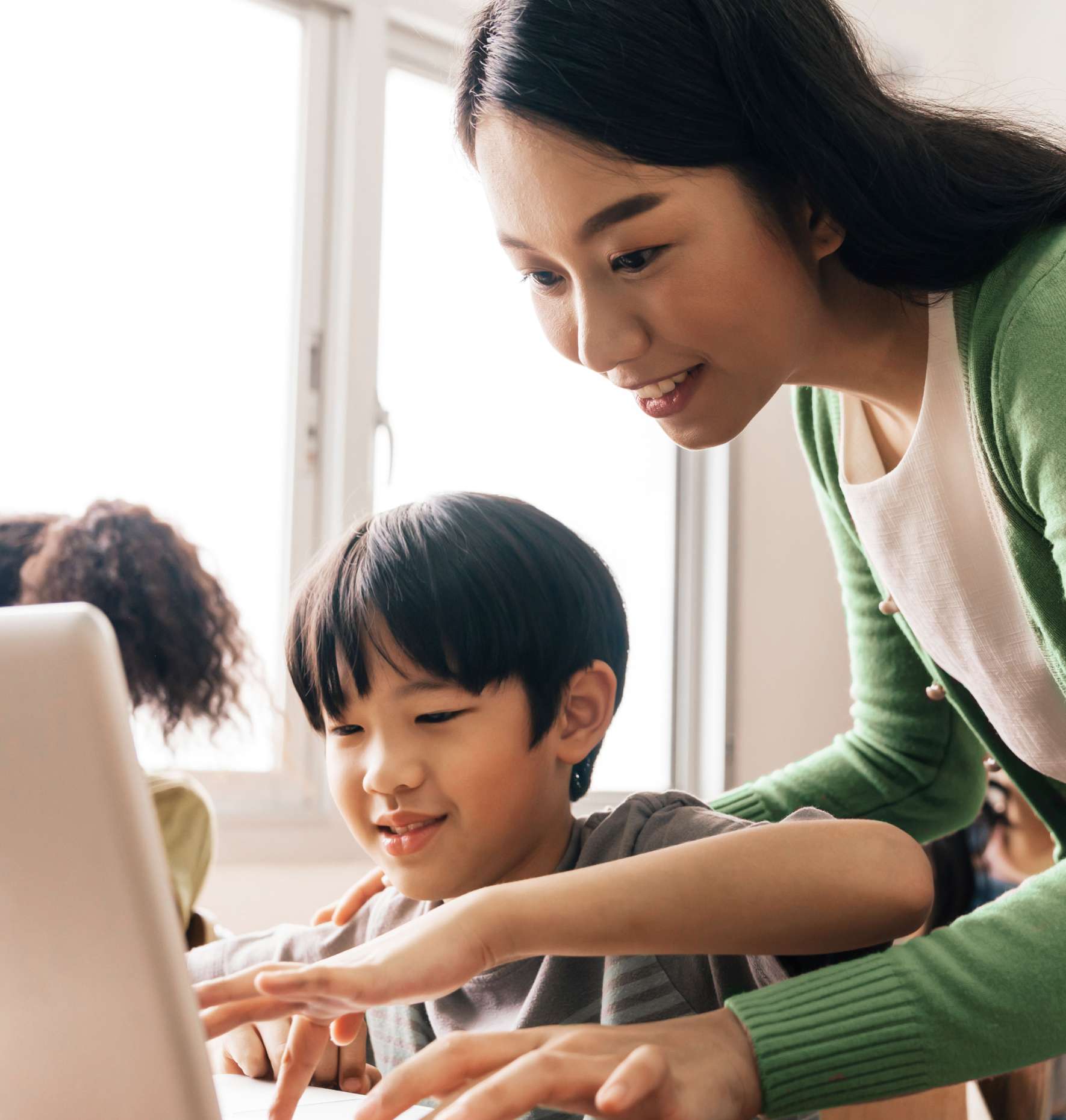 A teach and student reviewing work on the computer