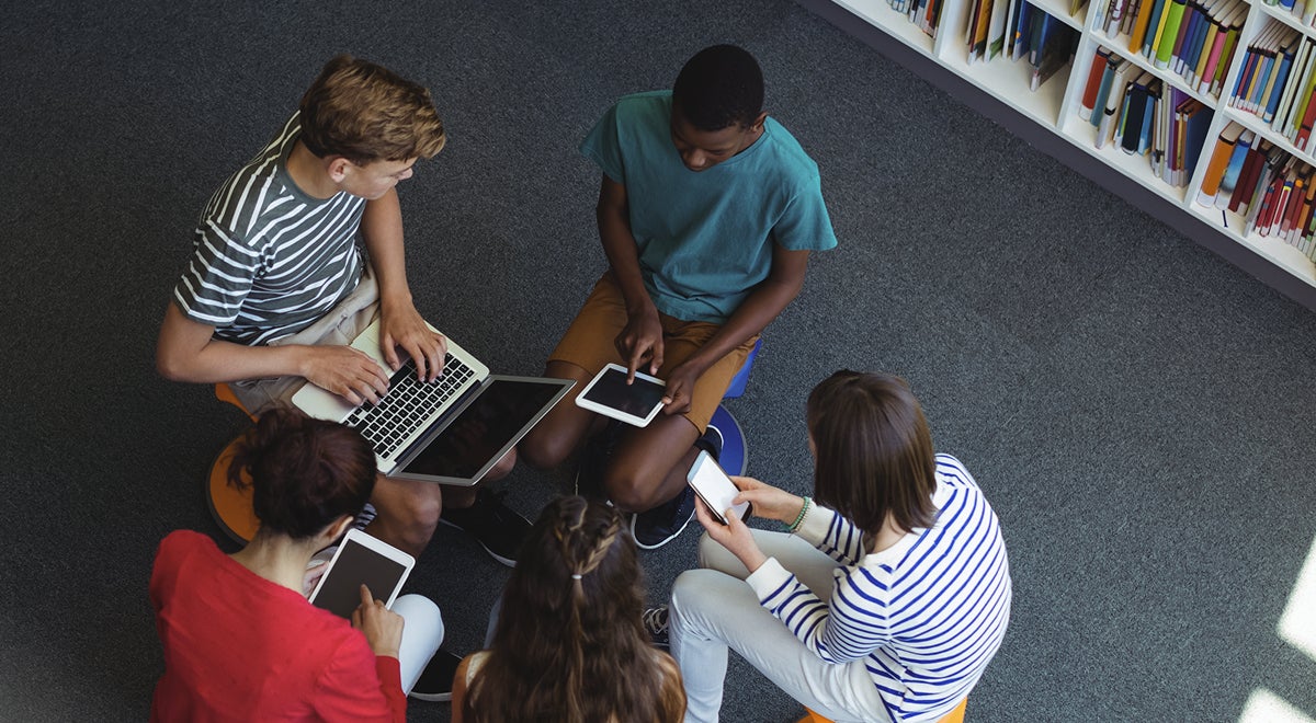 Students use tablets in a library