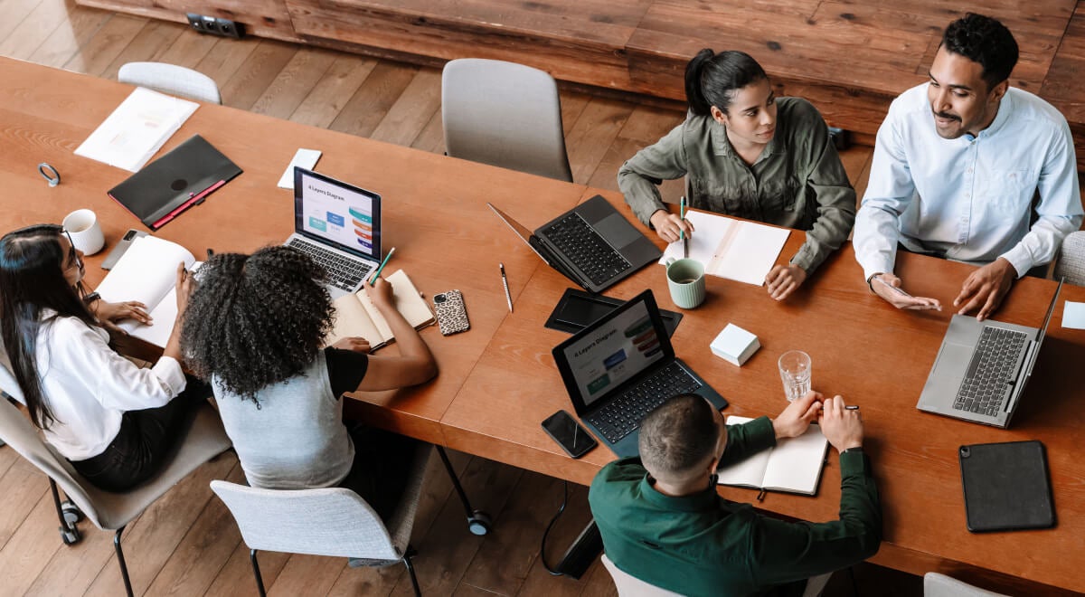 Students studying at a long conference table