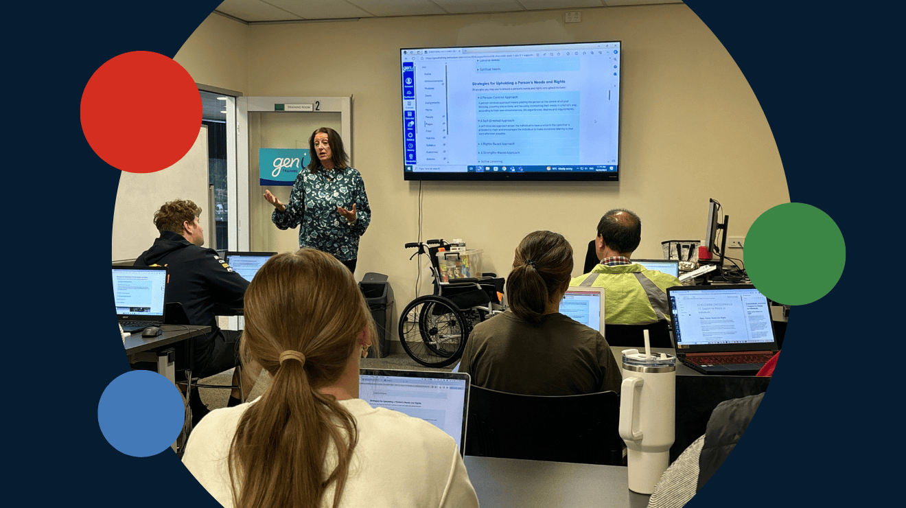An instructor at genU Training stands in front of a classroom with learners