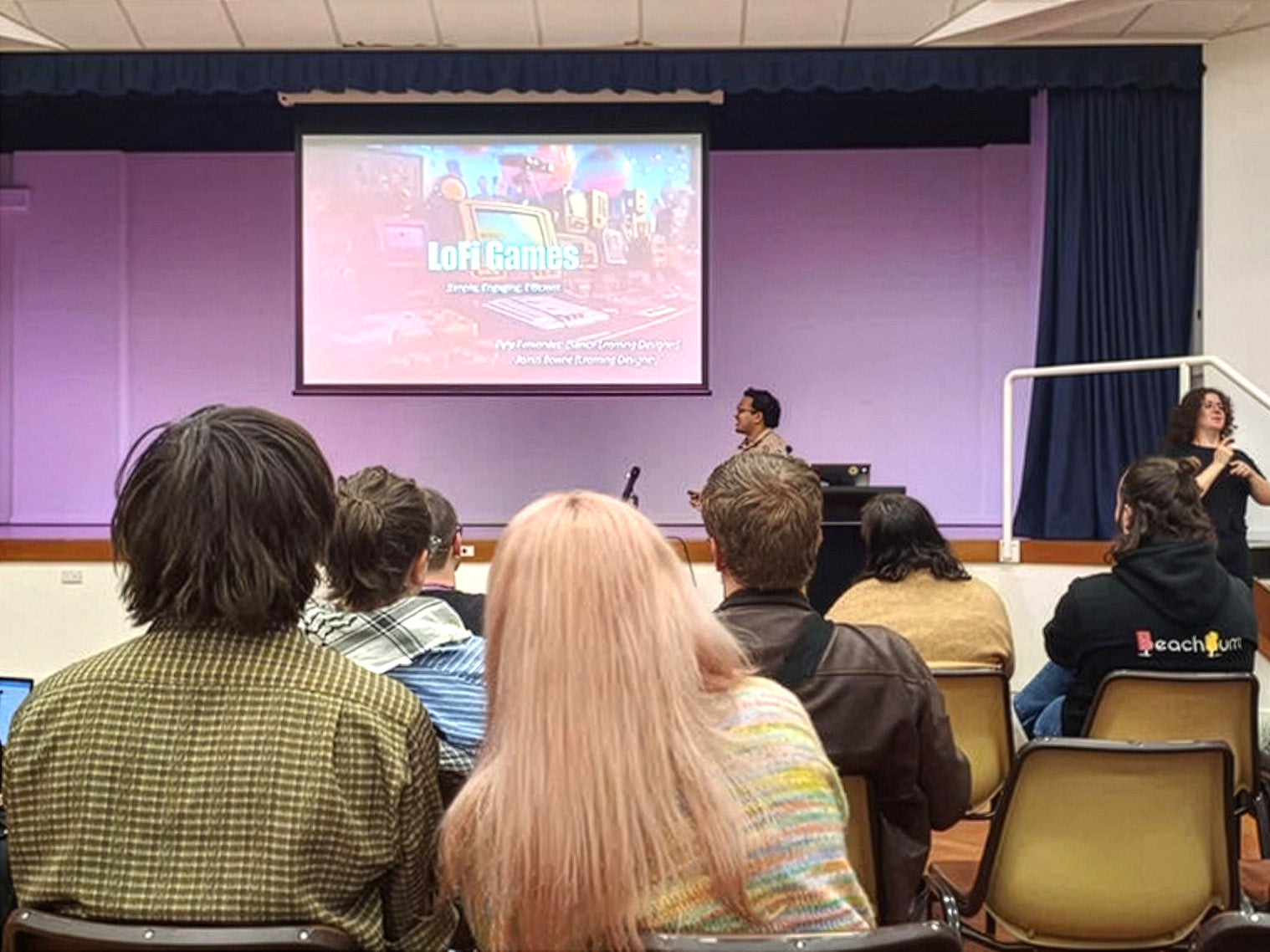 students in a class, looking at a projector screen