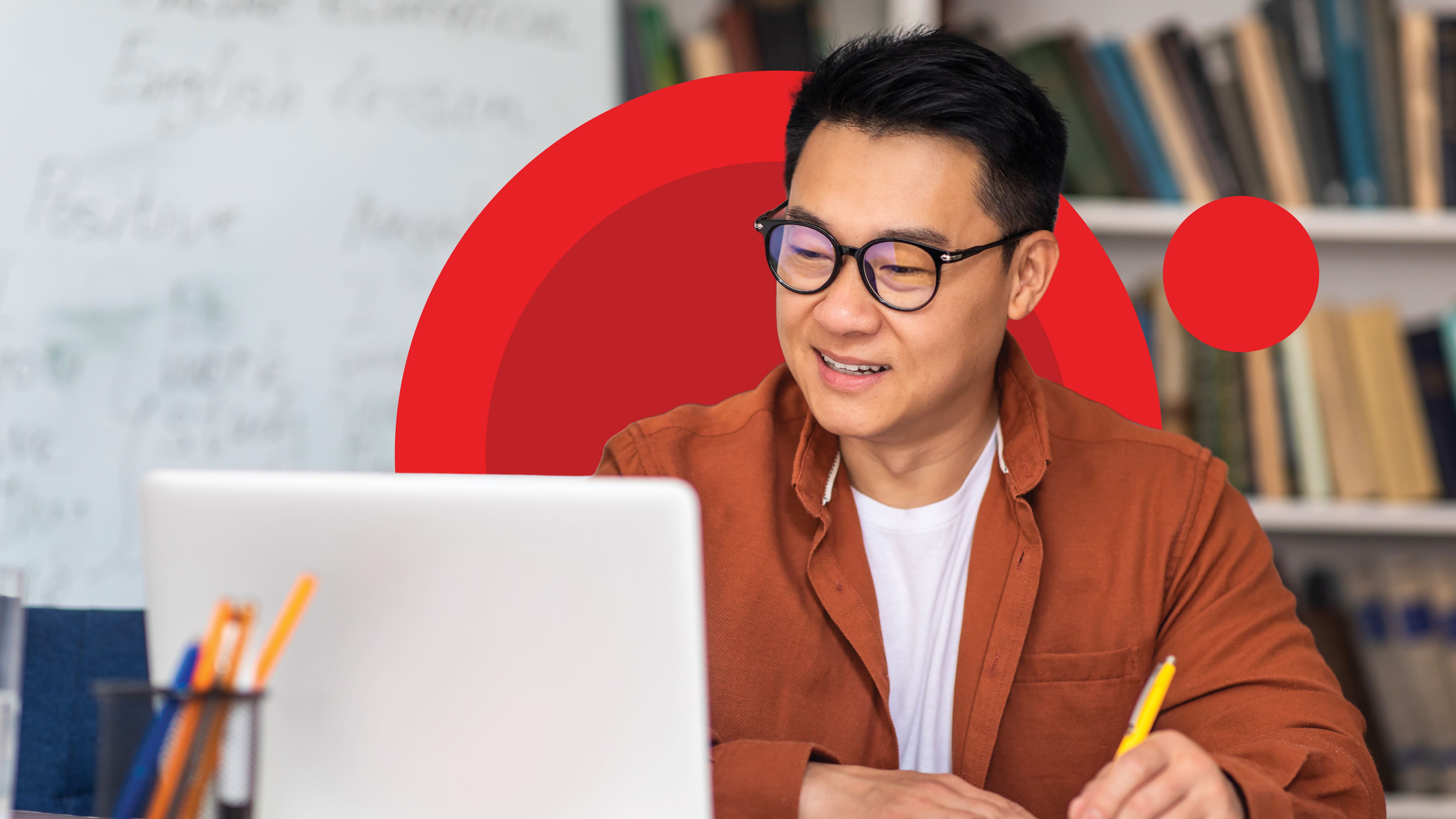an administrator works at a laptop in his office