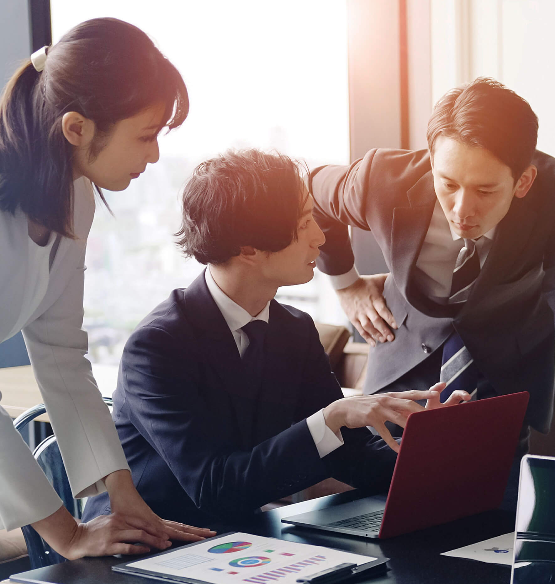 Three co-workers collaborating at a conference table
