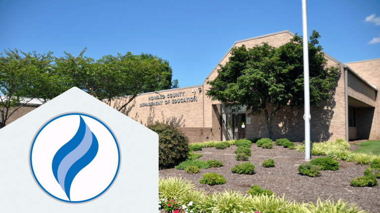 blue and white logo for Howard County Public Schools in front of image of school building