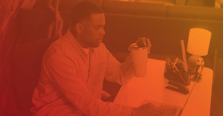 man sitting at his computer, working.