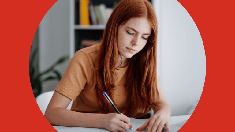 A woman focused on writing on paper with a pen, capturing her thoughts in a serene environment.