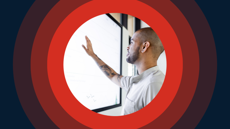 A man is pointing at a whiteboard