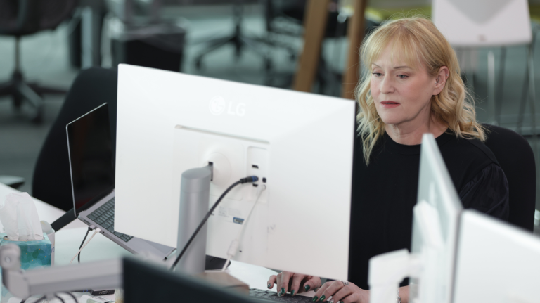 A woman working at a desk with a computer