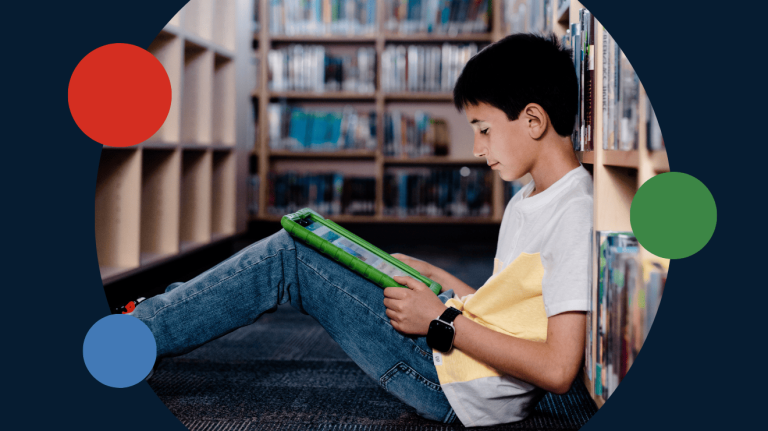 Young student using a tablet in a library, highlighting digital learning, edtech adoption, and K–12 student engagement.