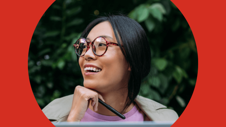 A woman in glasses, framed by a red background, focusing on her face and features.