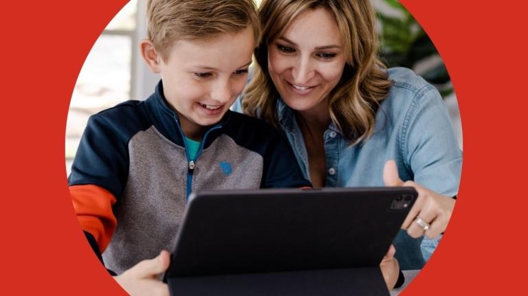 A mom sits with her son to look at grades