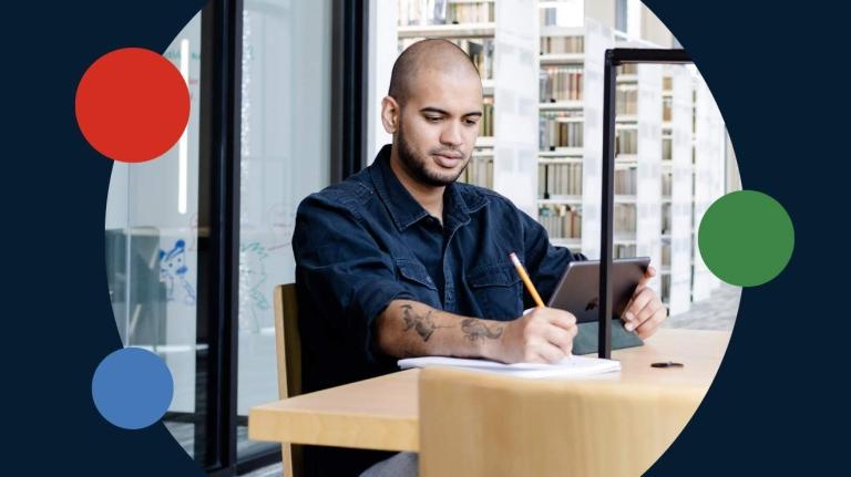 A man writing at a desk