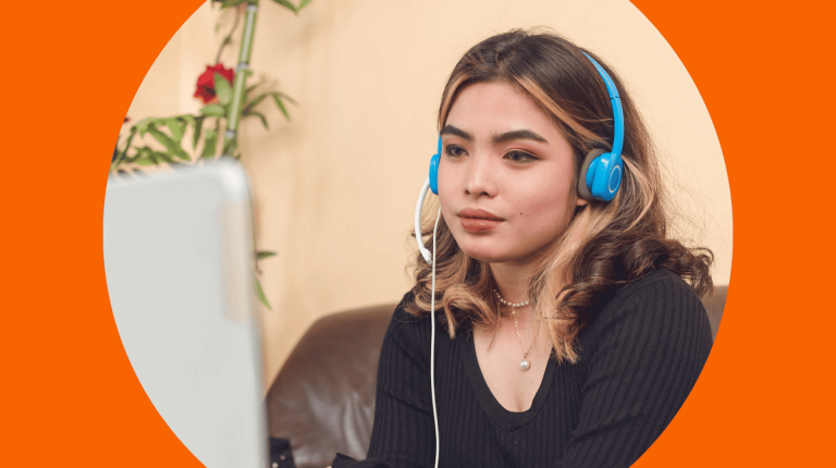 girl wearing headphones watches computer screen 