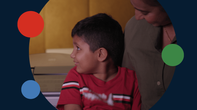 A young Yamaha Music Education student with his mother in the foreground