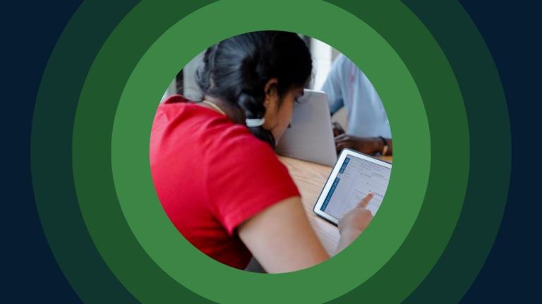 a student takes an assessment on a tablet in a classroom