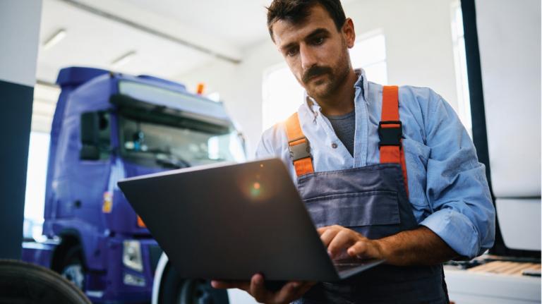 Worker using a laptop on a job site
