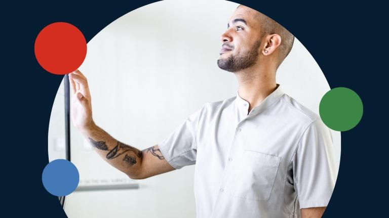 man standing in front of a large, interactive, touch-based screen