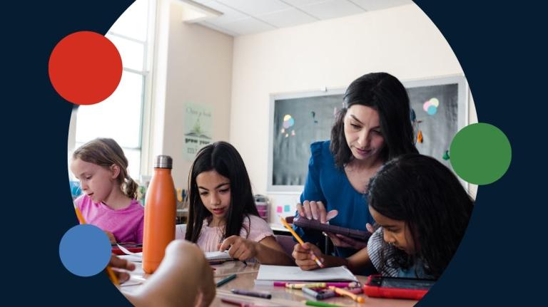 teacher working with grade school children on tablet