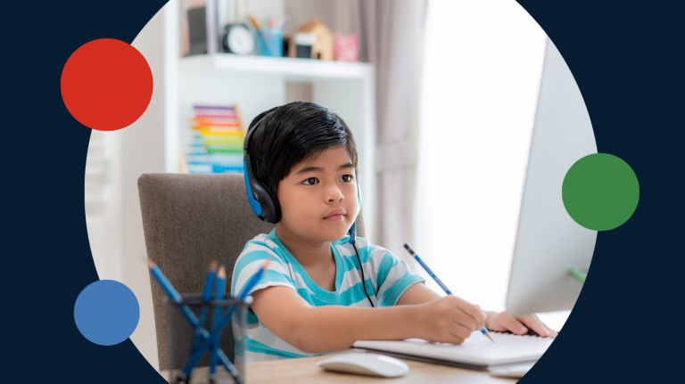 child with headphones, writing in a notebook