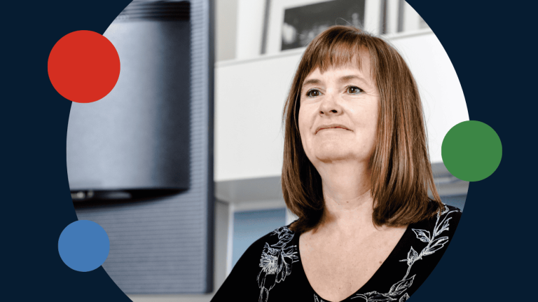 woman smiling while looking at the monitor