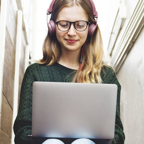 Person with headphones on working on laptop
