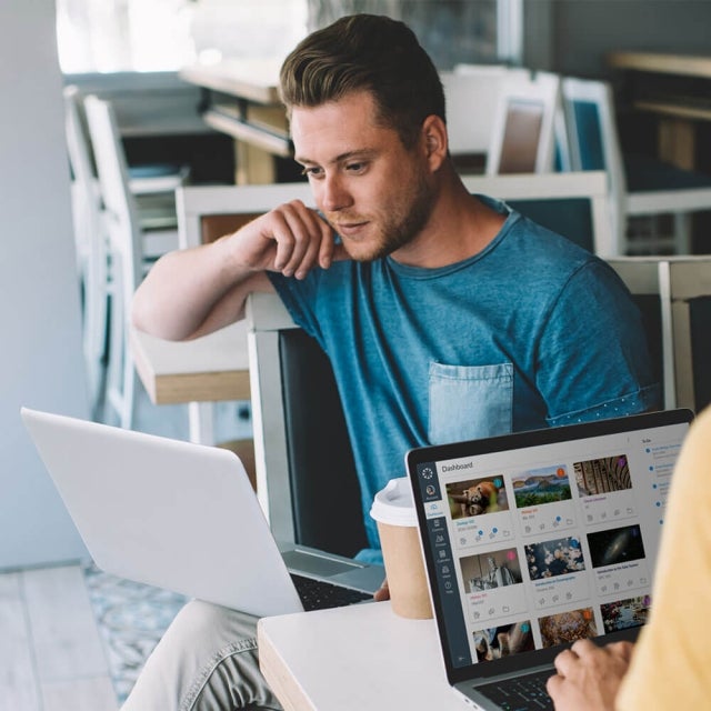 College student working on laptop sitting in chair