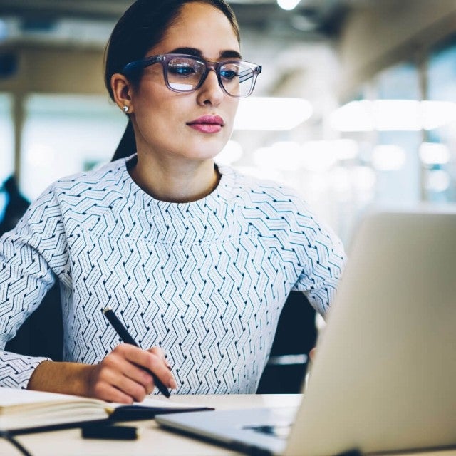 Person working on laptop at table