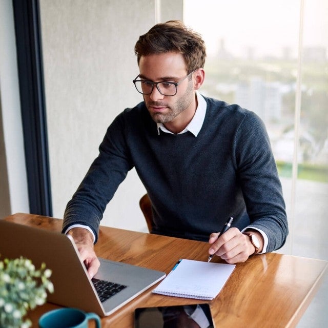 Person working in office at desk on laptop
