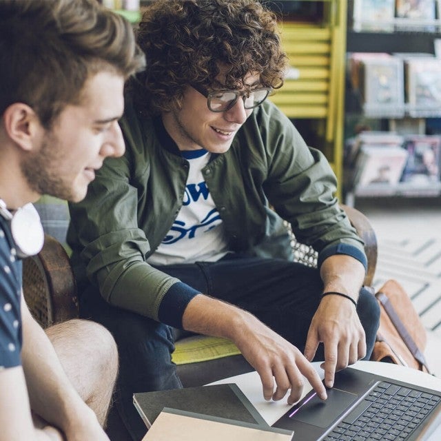 Two people working together on laptop