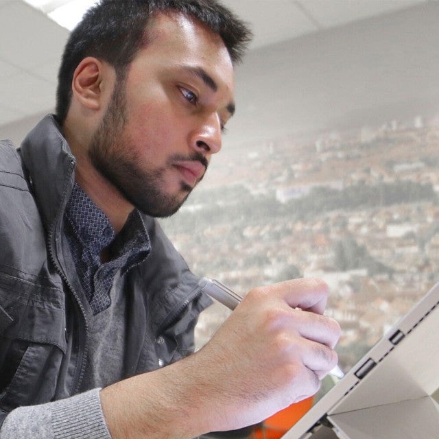 Student using tablet to work on Canvas