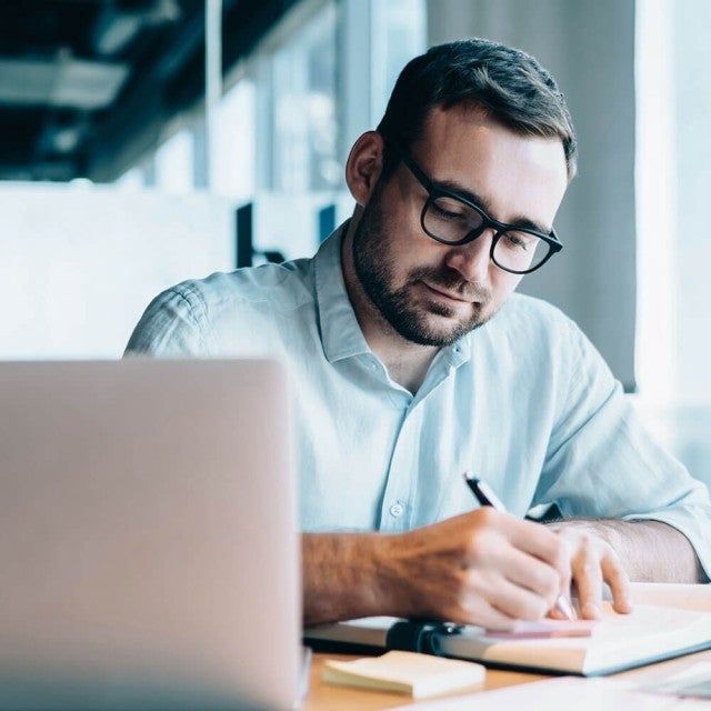 Student working in book on table