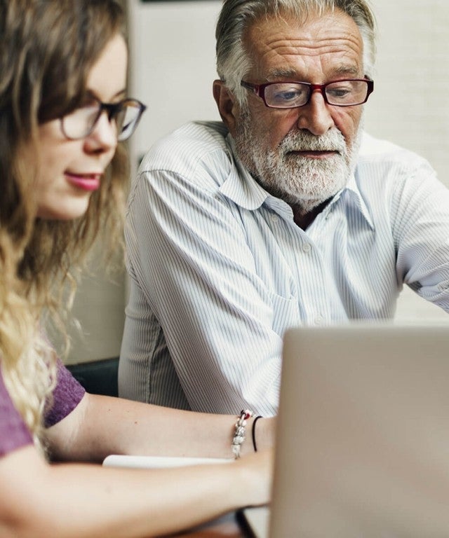 Professor and Student working together on laptop