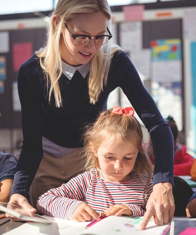 teacher working with student