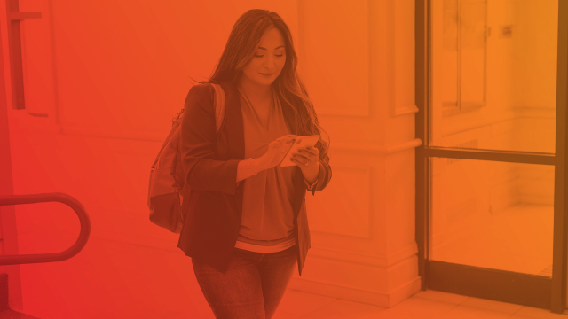 Woman with backpack walking on phone